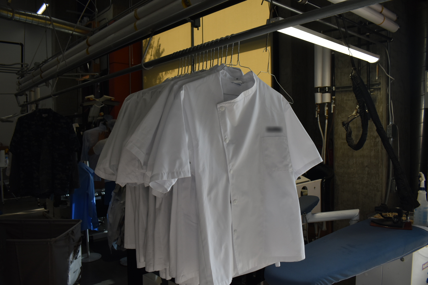 White chef coats hanging on a garment rail inside the Shelton plant